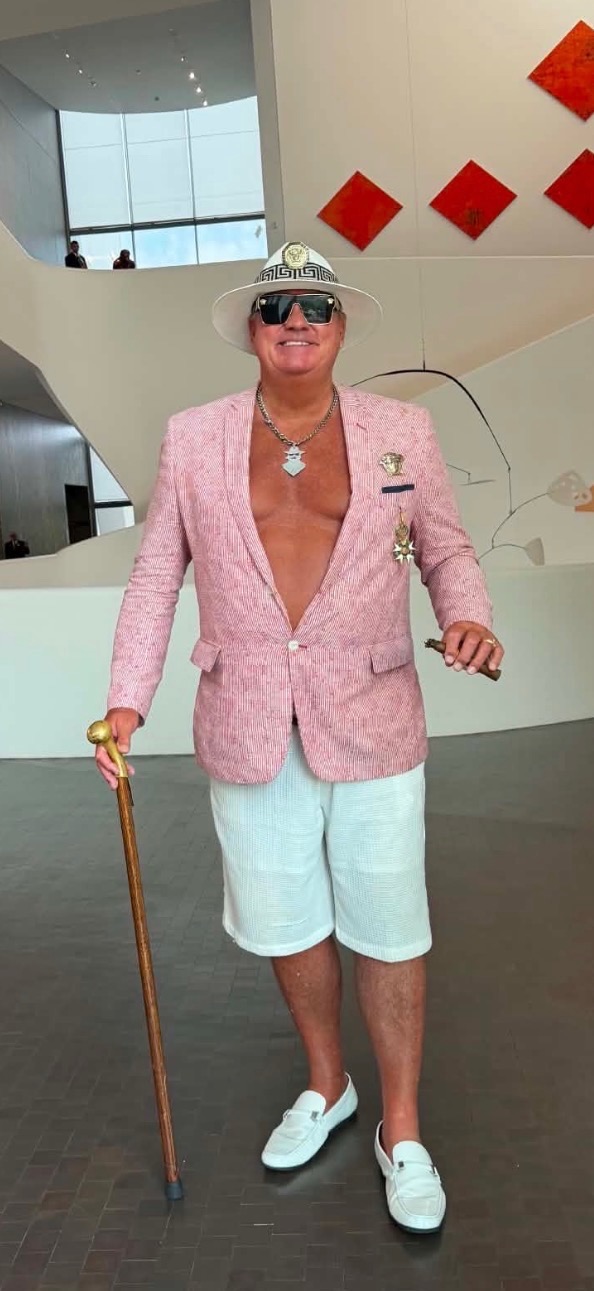 Phil in a pink jacket and white hat