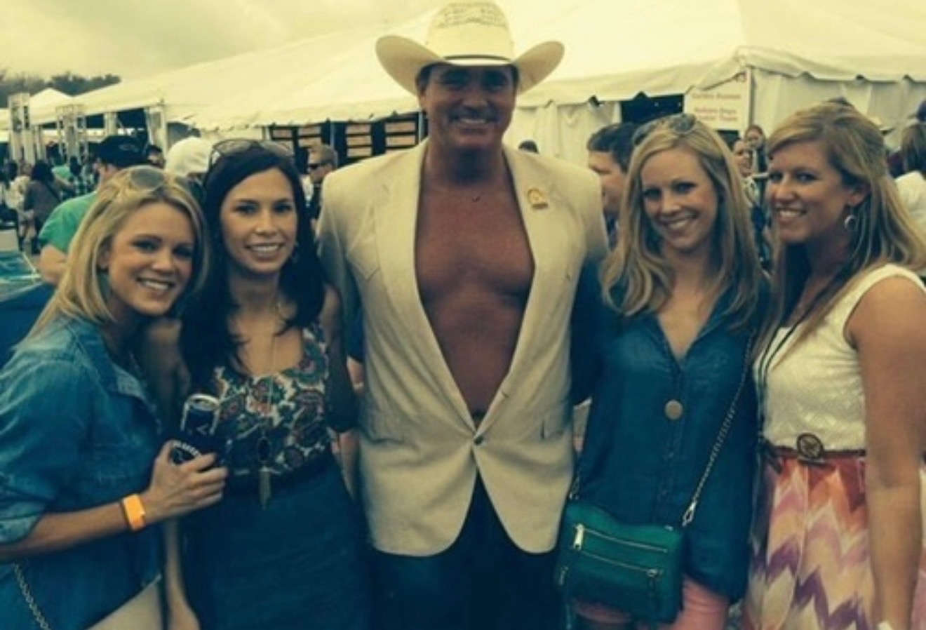 Phil in a cowboy hat posing with friends