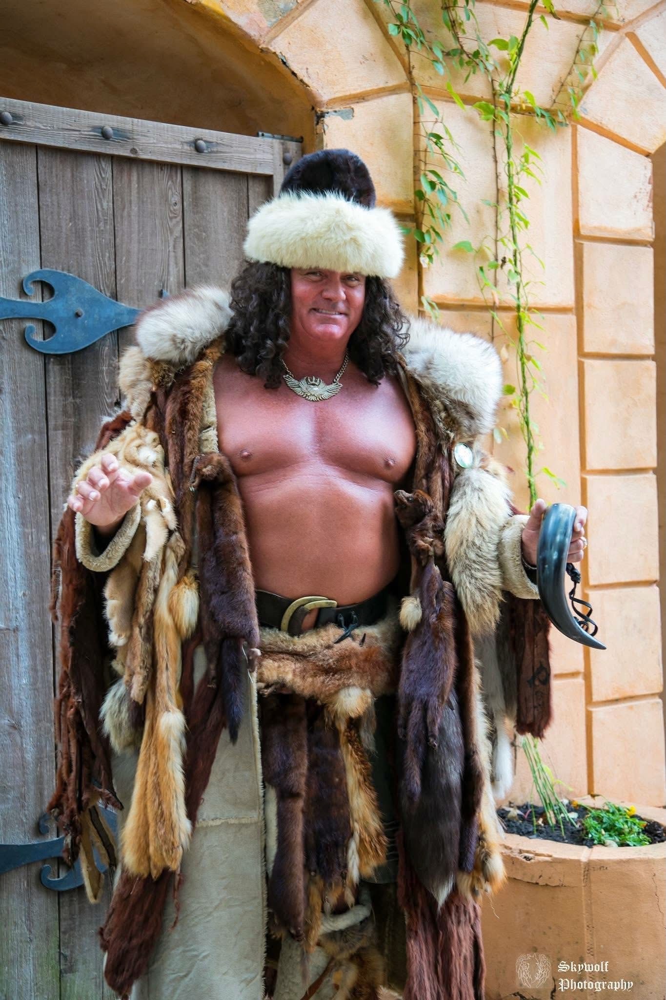 Phil in a fur costume holding a drinking horn